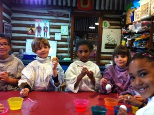 A group of egg dying kids having a blast with Miss Grace.